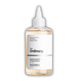 The Ordinary Glycolic Acid 7% Toning Solution in a clear plastic bottle with a white dropper cap, showing the pale yellow liquid inside, on a white background.